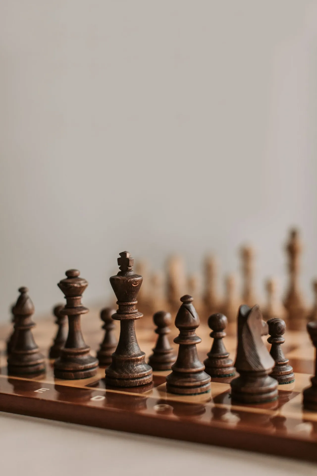 A wooden chess set on a board